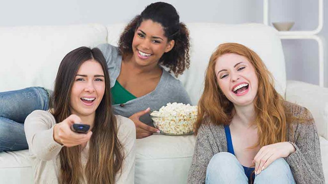 three women watching tv